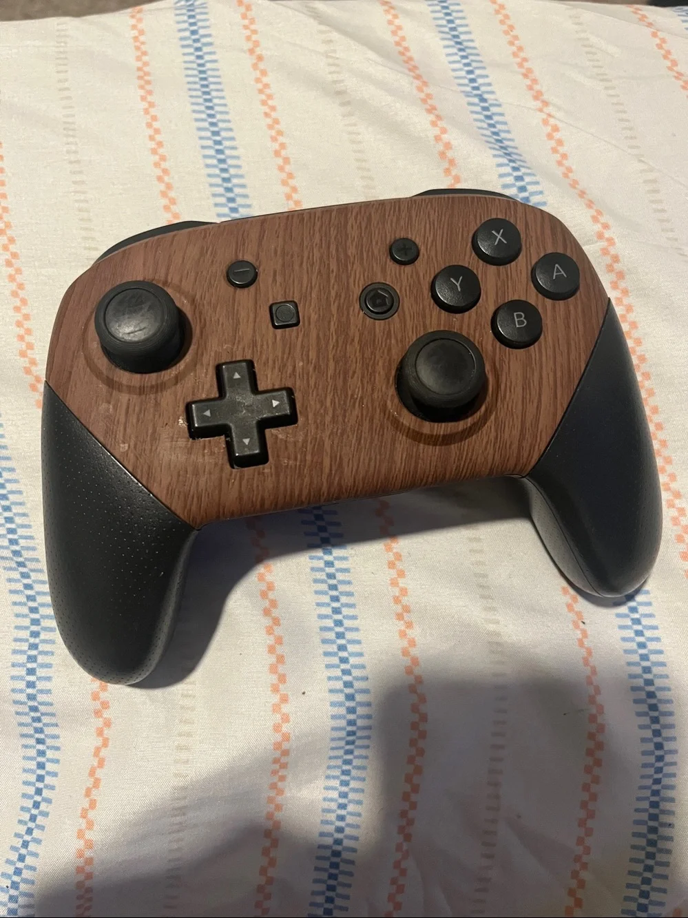 Nintendo Switch Pro Controller featuring a customized wood-grain